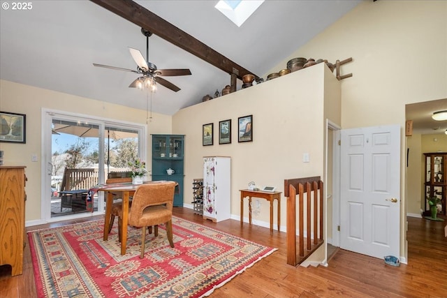 dining area featuring high vaulted ceiling, a skylight, beamed ceiling, and wood finished floors