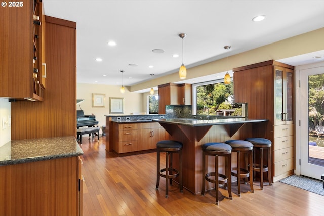 17810 Sarah Hill Ln, Lake Oswego, OR 97035 - kitchen with a peninsula, brown cabinets, plenty of natural light, light wood-type flooring, and recessed lighting