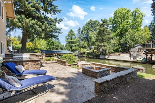 17810 Sarah Hill Ln, Lake Oswego, OR 97035 - view of patio with a fire pit, exterior kitchen, and a water view