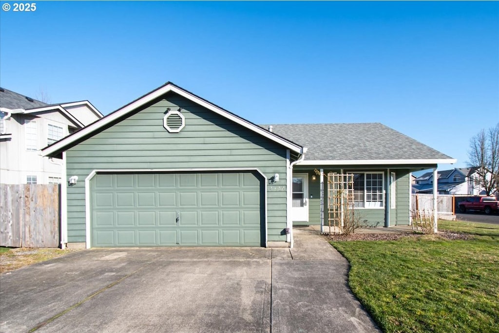 ranch-style house with a garage and a front lawn