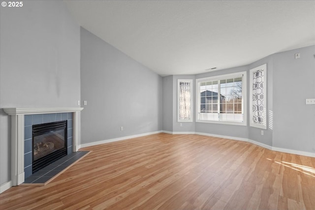 unfurnished living room featuring hardwood / wood-style floors and a fireplace