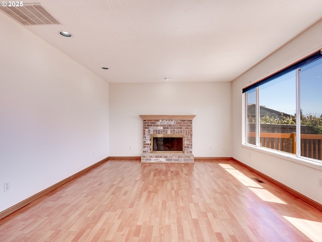 13811 SE 36th St, Vancouver, WA 98683 - unfurnished living room featuring light wood-type flooring, baseboards, a fireplace, and recessed lighting
