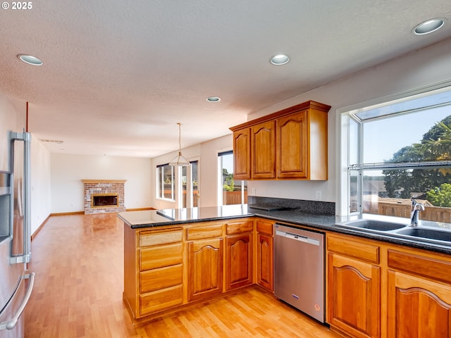 13811 SE 36th St, Vancouver, WA 98683 - kitchen with stainless steel dishwasher, a sink, a peninsula, light wood finished floors, and recessed lighting