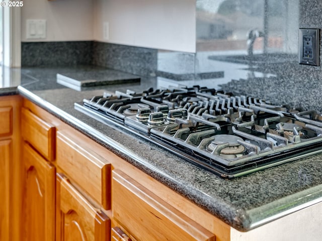 13811 SE 36th St, Vancouver, WA 98683 - kitchen view of gas stovetop, brown cabinets, backsplash, and dark countertops