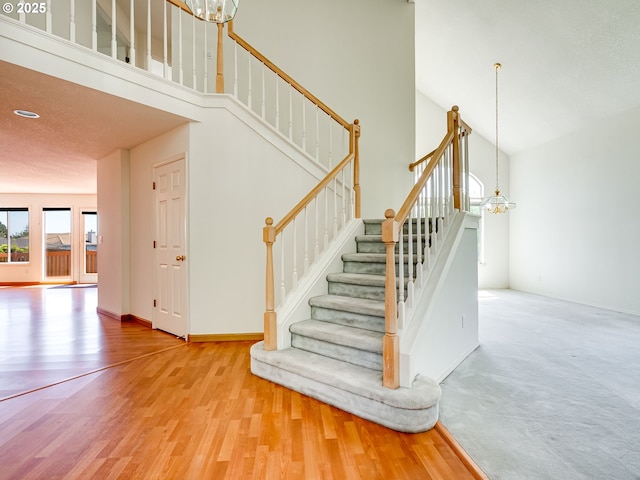 13811 SE 36th St, Vancouver, WA 98683 - staircase featuring a chandelier, a towering ceiling, wood finished floors, and baseboards