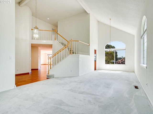 13811 SE 36th St, Vancouver, WA 98683 - unfurnished living room featuring high vaulted ceiling, carpet, healthy amount of natural light, stairs, and baseboards