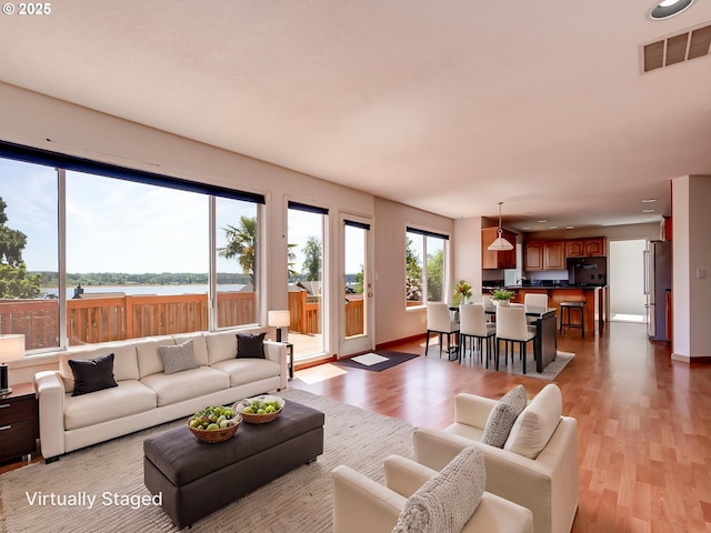 13811 SE 36th St, Vancouver, WA 98683 - living area featuring light wood-style floors, a water view, baseboards, and recessed lighting