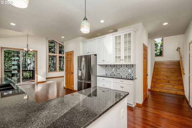 kitchen with dark wood-style flooring, tasteful backsplash, glass insert cabinets, white cabinetry, and stainless steel fridge with ice dispenser