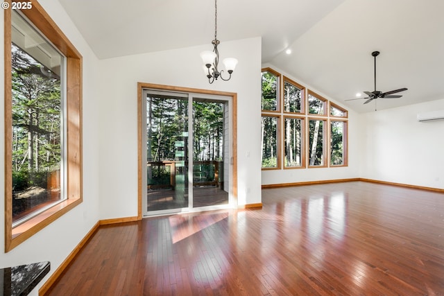 interior space featuring lofted ceiling, hardwood / wood-style flooring, plenty of natural light, and a wall mounted AC