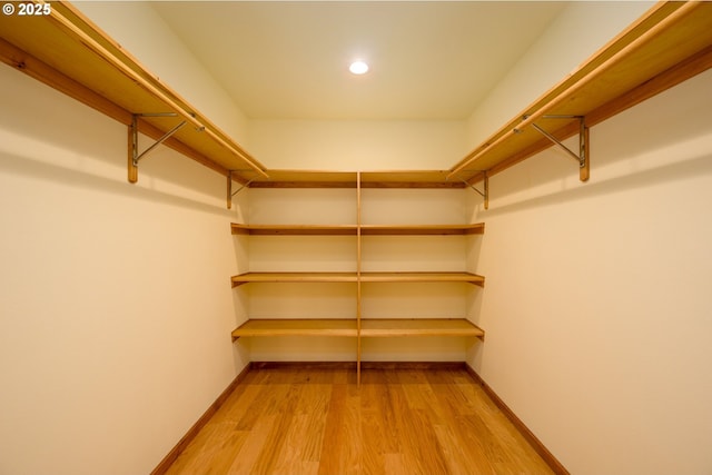 spacious closet featuring light wood-style flooring