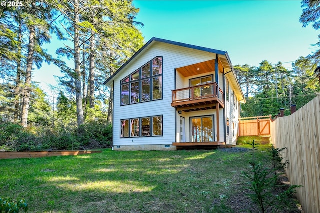 back of house featuring a yard, crawl space, fence, and a balcony