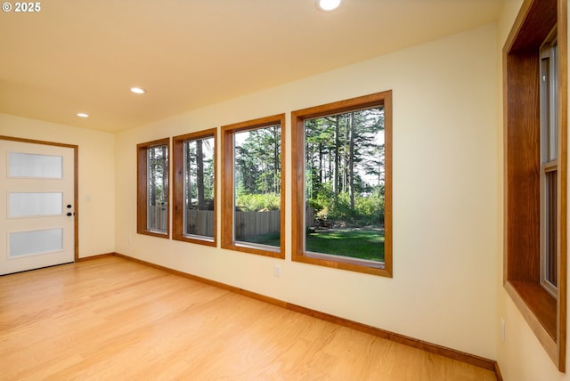 doorway featuring recessed lighting, light wood-style flooring, and baseboards