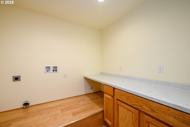 laundry area featuring hookup for a washing machine, cabinet space, light wood-style floors, and hookup for an electric dryer