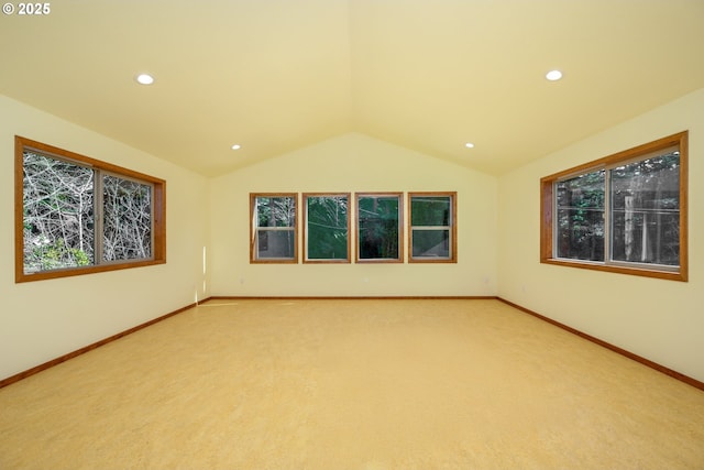 unfurnished room featuring lofted ceiling, recessed lighting, baseboards, and light colored carpet