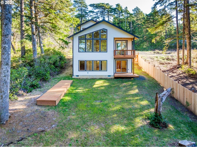 back of house with a yard, crawl space, fence, and a wooden deck