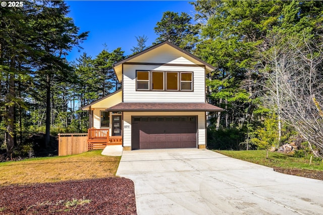 view of front of house featuring a garage, driveway, and a front lawn