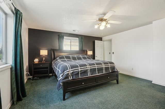 carpeted bedroom with visible vents, a ceiling fan, baseboards, and a textured ceiling