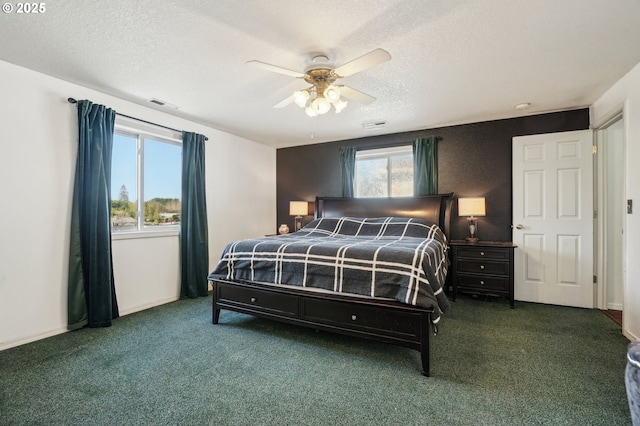 carpeted bedroom with ceiling fan, a textured ceiling, and visible vents
