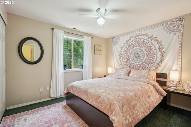 carpeted bedroom with visible vents, a ceiling fan, and baseboards