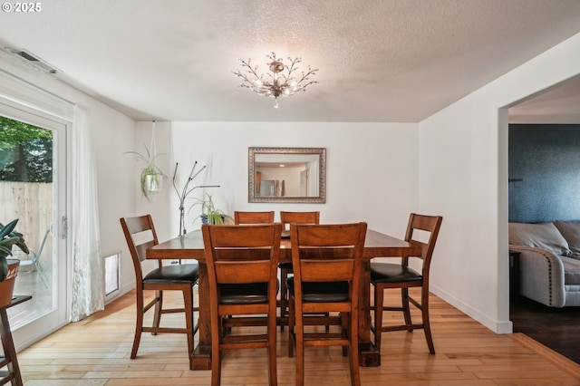 dining area featuring light wood-style flooring