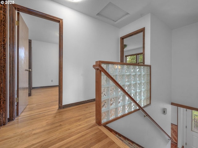 18036 NW Emmaus Ln, Portland, OR 97231 - hallway with an upstairs landing, wood finished floors, attic access, and baseboards
