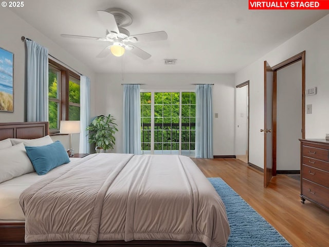 18036 NW Emmaus Ln, Portland, OR 97231 - bedroom with light wood-style flooring, baseboards, and a ceiling fan