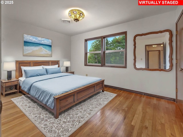 18036 NW Emmaus Ln, Portland, OR 97231 - bedroom with light wood-style flooring and baseboards