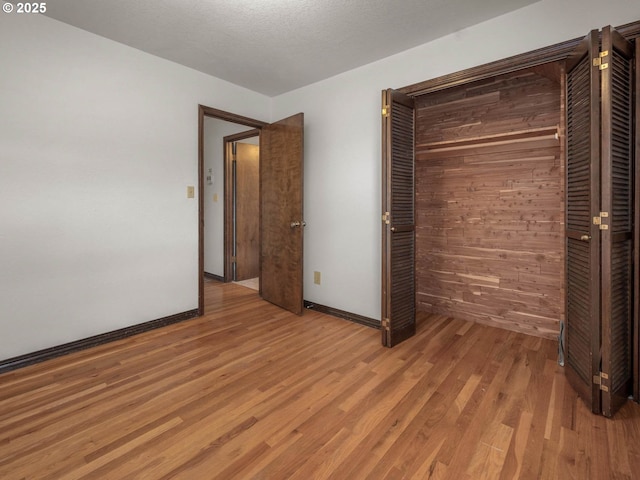 18036 NW Emmaus Ln, Portland, OR 97231 - unfurnished bedroom featuring light wood-style floors, baseboards, and wooden walls