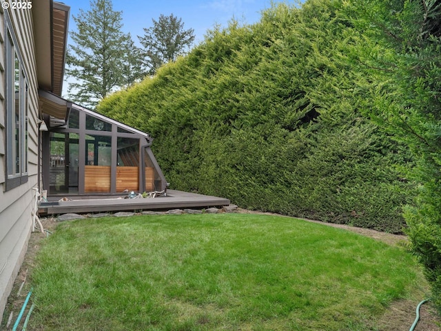 18036 NW Emmaus Ln, Portland, OR 97231 - view of green lawn with a deck and a sunroom