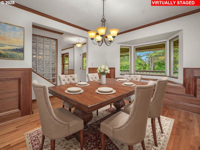 18036 NW Emmaus Ln, Portland, OR 97231 - dining space with a chandelier, ornamental molding, and light wood-type flooring