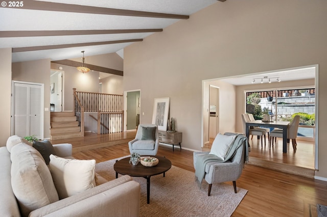 living room with wood-type flooring, beam ceiling, and high vaulted ceiling