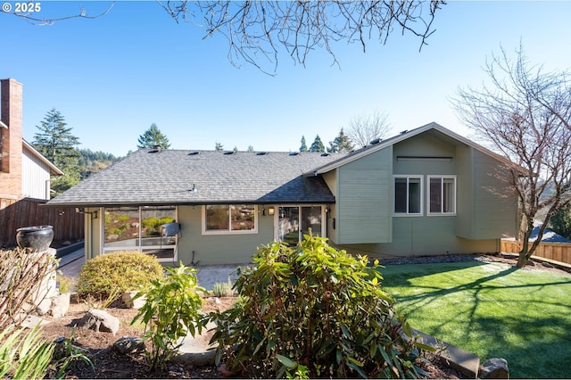 rear view of house featuring a lawn and a patio area