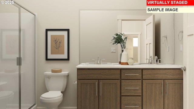 bathroom featuring double vanity, toilet, a shower stall, and a sink