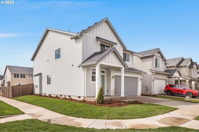 view of front of home with a front yard, fence, a residential view, a shingled roof, and board and batten siding