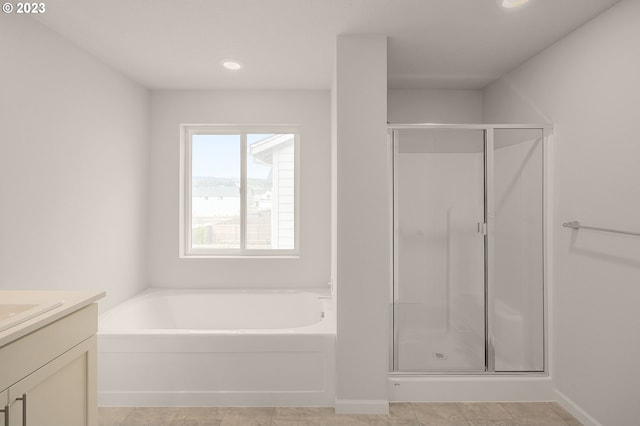 full bath featuring a shower stall, vanity, and a garden tub