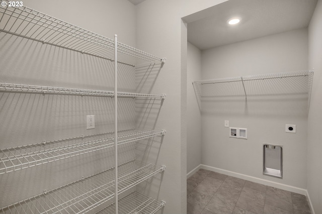 laundry area featuring laundry area, electric dryer hookup, baseboards, and washer hookup