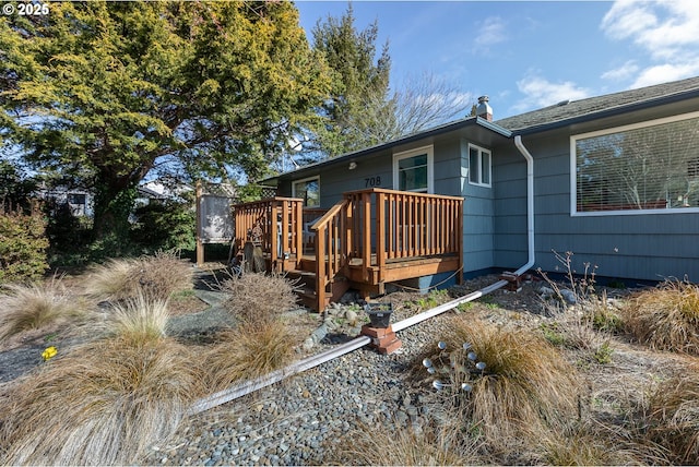 rear view of property featuring a deck