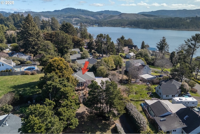 bird's eye view featuring a residential view, a view of trees, and a water and mountain view