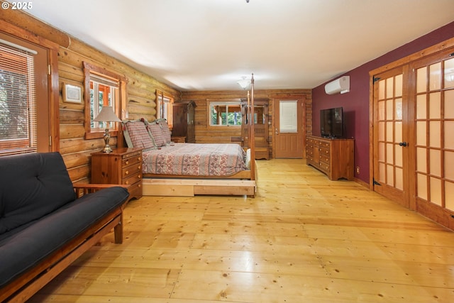 bedroom featuring log walls, a wall mounted AC, french doors, and light wood-style flooring