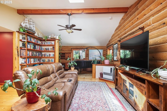 living room with lofted ceiling with beams, rustic walls, wood finished floors, and ceiling fan