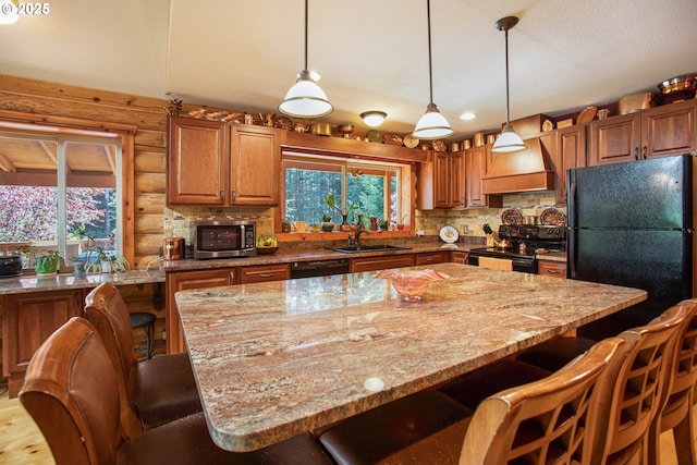 kitchen with premium range hood, plenty of natural light, a sink, and black appliances