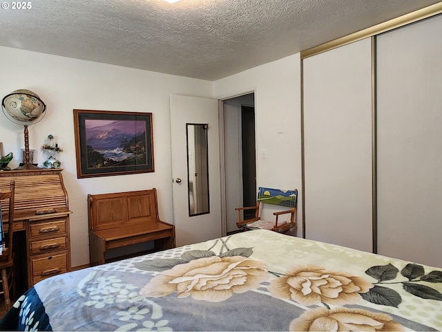 bedroom with a closet and a textured ceiling