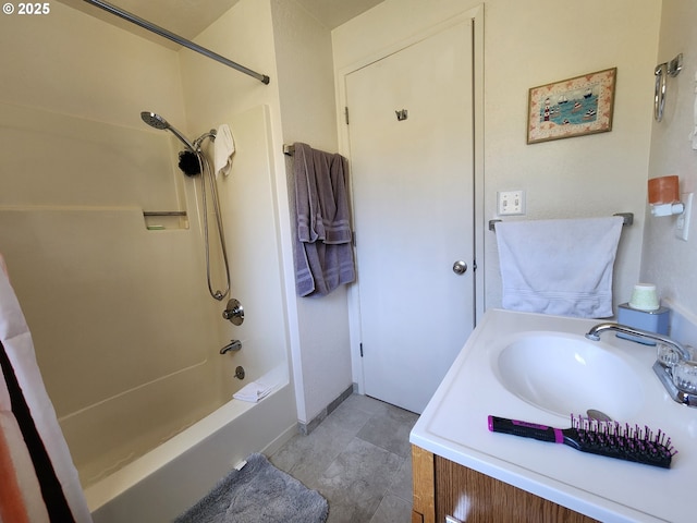 bathroom with baseboards, vanity, and bathtub / shower combination