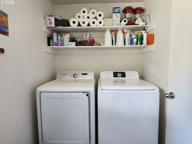 washroom with washing machine and clothes dryer and laundry area