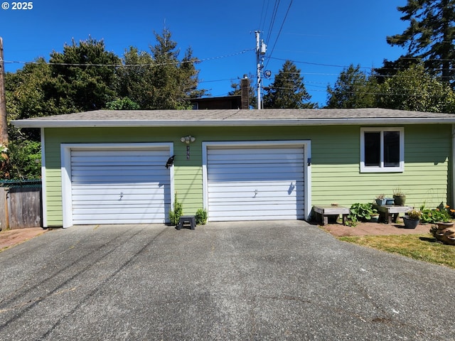 detached garage featuring driveway