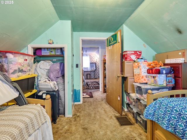 carpeted bedroom with vaulted ceiling