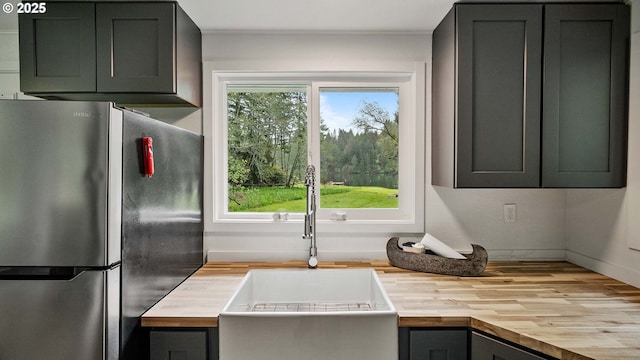 1298 N Tenmile, Lakeside, OR 97449 - kitchen with a sink, freestanding refrigerator, wood counters, and wood finished floors