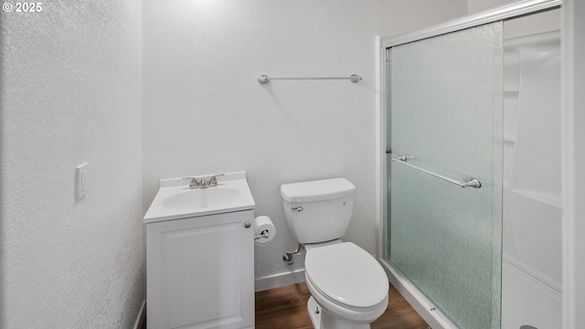 1298 N Tenmile, Lakeside, OR 97449 - full bath featuring toilet, a textured wall, a shower stall, vanity, and wood finished floors