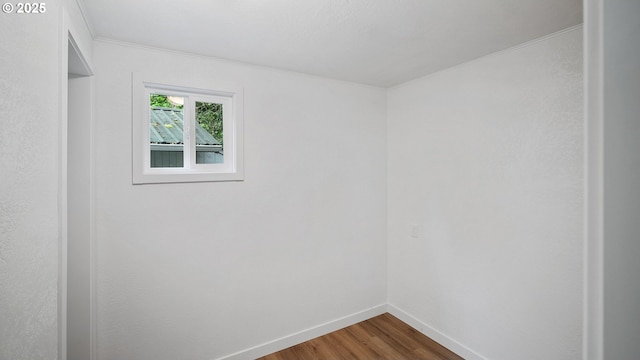 1298 N Tenmile, Lakeside, OR 97449 - unfurnished room featuring dark wood-type flooring, baseboards, and crown molding