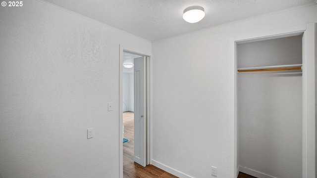 1298 N Tenmile, Lakeside, OR 97449 - unfurnished bedroom featuring baseboards, a closet, ornamental molding, and wood finished floors
